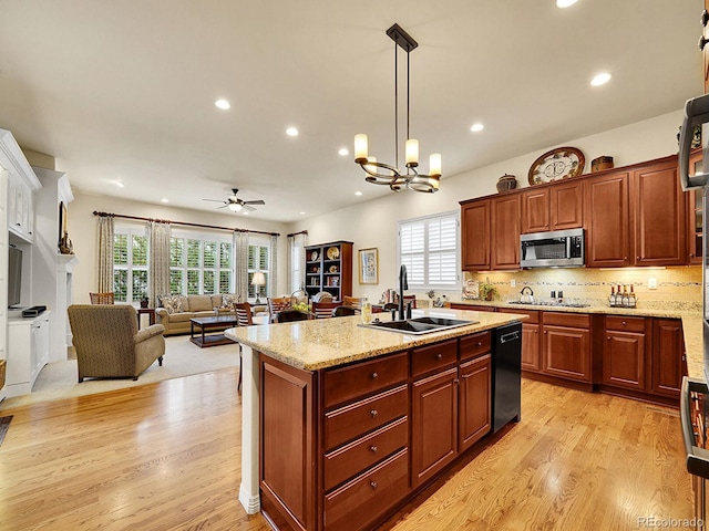 2571 Hunters Pl, Highlands Ranch, CO 80129 - kitchen featuring ceiling fan with notable chandelier, a sink, stainless steel appliances, light wood-type flooring, and recessed lighting