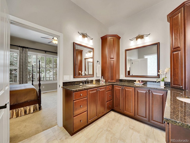 2571 Hunters Pl, Highlands Ranch, CO 80129 - bathroom with ceiling fan, double vanity, vaulted ceiling, and connected bathroom
