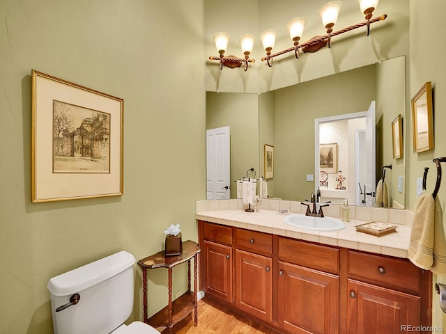 2571 Hunters Pl, Highlands Ranch, CO 80129 - bathroom with toilet, vanity, and wood finished floors