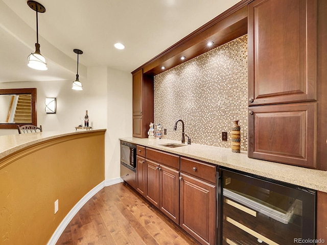 2571 Hunters Pl, Highlands Ranch, CO 80129 - bar featuring a sink, wine cooler, decorative light fixtures, decorative backsplash, and black microwave