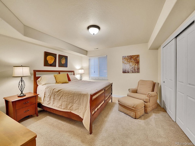 2571 Hunters Pl, Highlands Ranch, CO 80129 - bedroom featuring baseboards, light carpet, a closet, and a textured ceiling