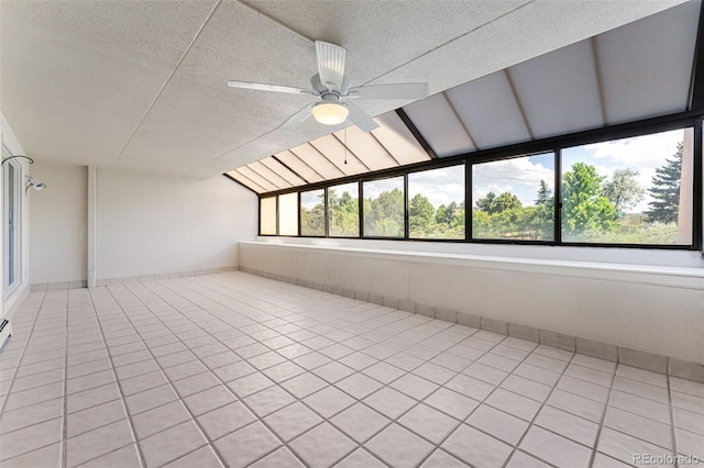 unfurnished sunroom featuring ceiling fan and lofted ceiling