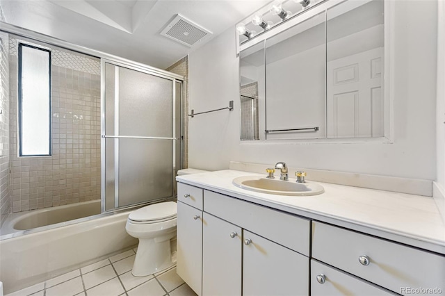 full bathroom featuring toilet, vanity, tile patterned floors, and shower / bath combination with glass door