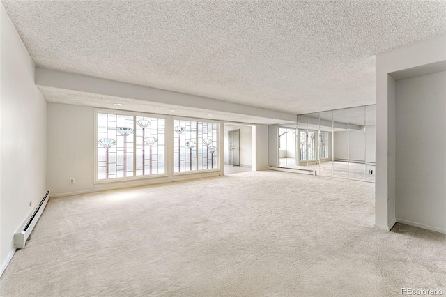 7000 E Quincy Ave Unit 204, Denver, CO 80237 - unfurnished room with a baseboard heating unit, carpet flooring, a textured ceiling, and baseboards