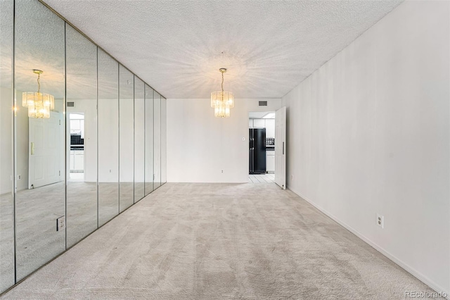 7000 E Quincy Ave Unit 204, Denver, CO 80237 - carpeted empty room with a chandelier and a textured ceiling