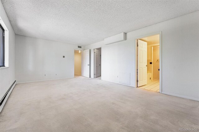 7000 E Quincy Ave Unit 204, Denver, CO 80237 - spare room with carpet flooring, a baseboard radiator, a textured ceiling, and baseboards