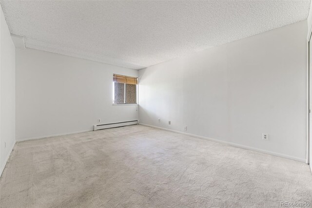 7000 E Quincy Ave Unit 204, Denver, CO 80237 - carpeted spare room featuring baseboard heating, a textured ceiling, and baseboards