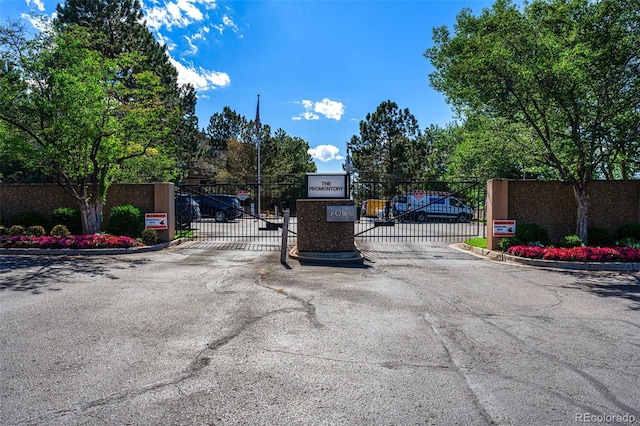 7000 E Quincy Ave Unit 204, Denver, CO 80237 - view of asphalt road with a gate, a gated entry, and curbs