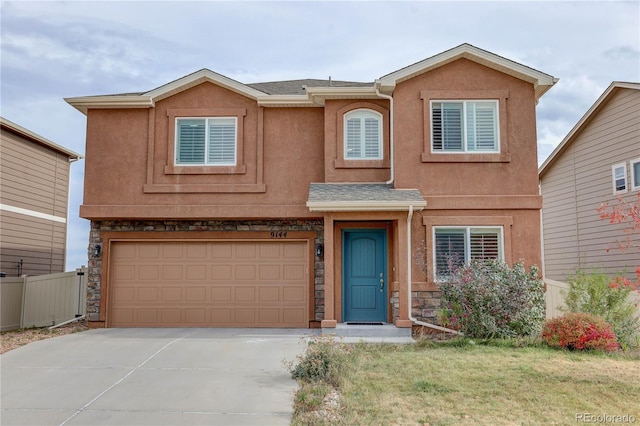 view of front of home featuring a front yard and a garage