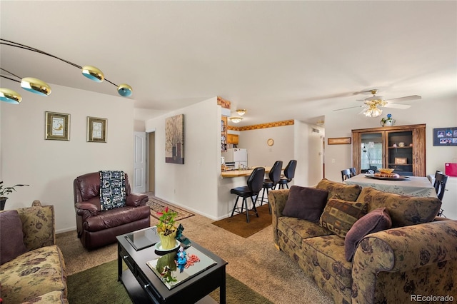 carpeted living room with ceiling fan