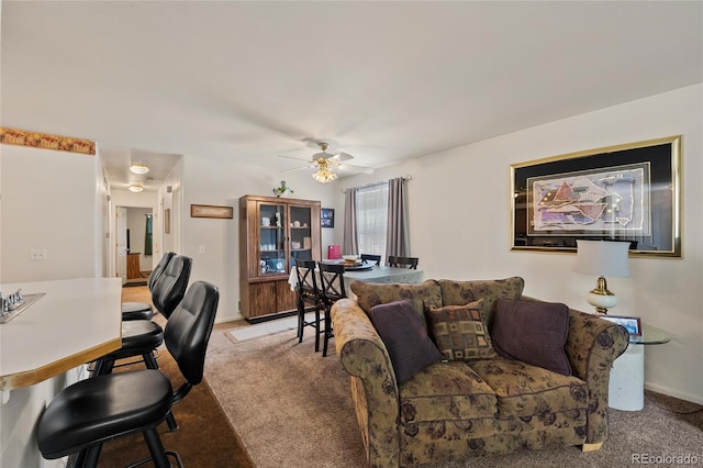 carpeted living room featuring ceiling fan