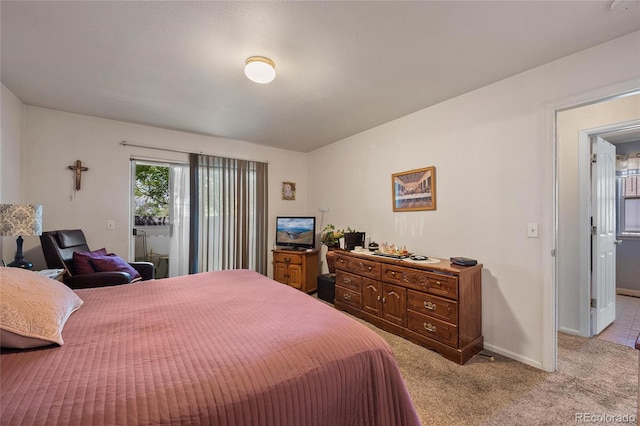 bedroom featuring light carpet