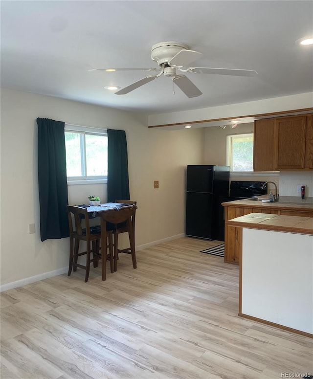 57920 US Highway 285 Unit 23/24, Bailey, CO 80421 - kitchen featuring freestanding refrigerator, tile countertops, light wood-style flooring, a ceiling fan, and recessed lighting