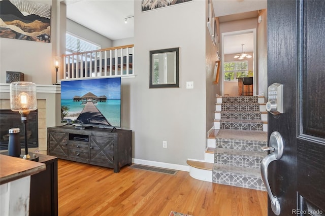 2933 Central Park Blvd, Denver, CO 80238 - living area with stairs, wood finished floors, and baseboards