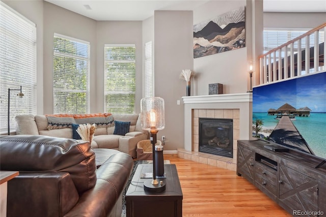 2933 Central Park Blvd, Denver, CO 80238 - living room with light wood-type flooring, a tile fireplace, and baseboards
