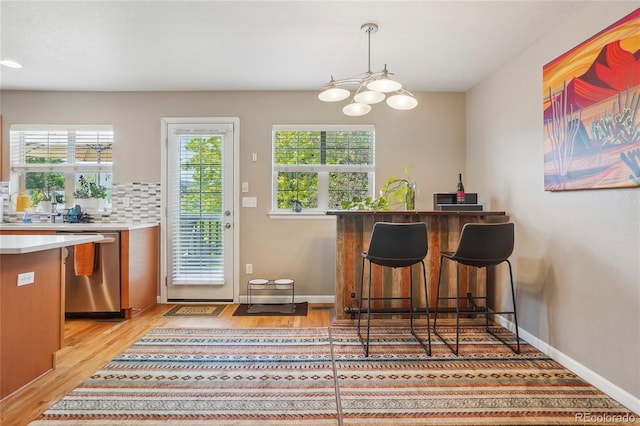 2933 Central Park Blvd, Denver, CO 80238 - indoor dry bar featuring dishwasher, light wood-style flooring, and plenty of natural light