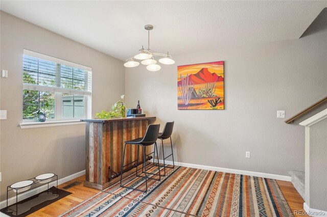 2933 Central Park Blvd, Denver, CO 80238 - indoor dry bar featuring wood finished floors, baseboards, and decorative light fixtures