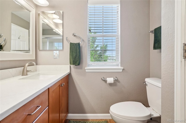 2933 Central Park Blvd, Denver, CO 80238 - bathroom featuring toilet, vanity, and baseboards