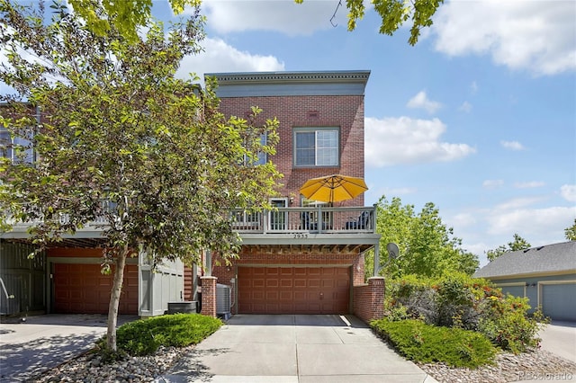 2933 Central Park Blvd, Denver, CO 80238 - view of front of home featuring brick siding, a garage, and concrete driveway
