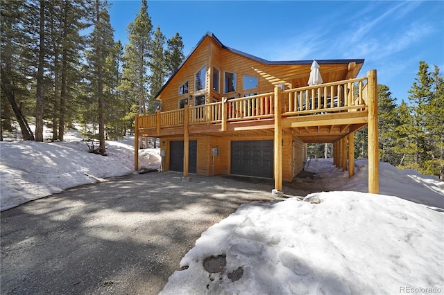 exterior space featuring a garage and a deck