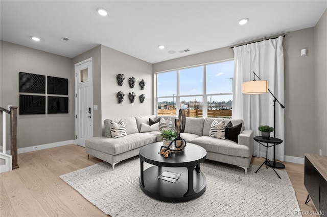 living room with light hardwood / wood-style flooring