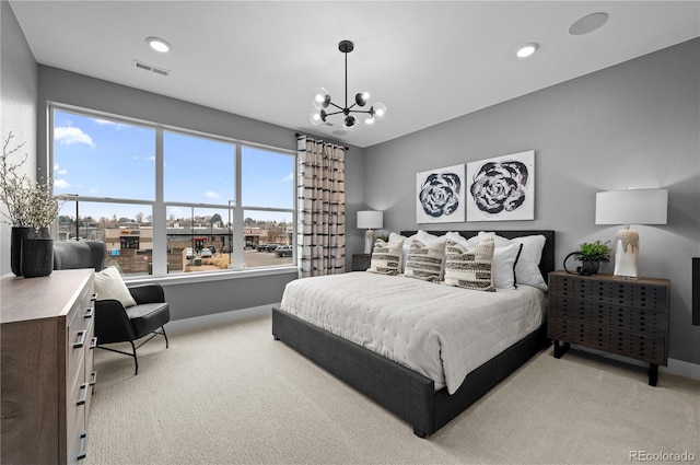 carpeted bedroom featuring a chandelier