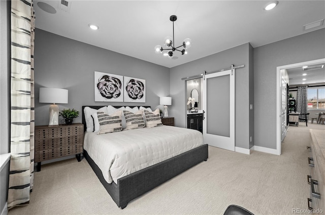 carpeted bedroom featuring ensuite bathroom, a chandelier, and a barn door