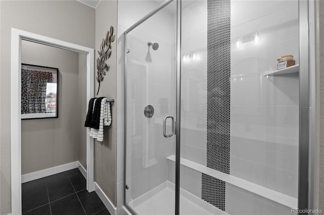 bathroom with a shower with door and tile patterned flooring