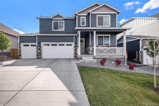 view of front of property with a front lawn, covered porch, and a garage