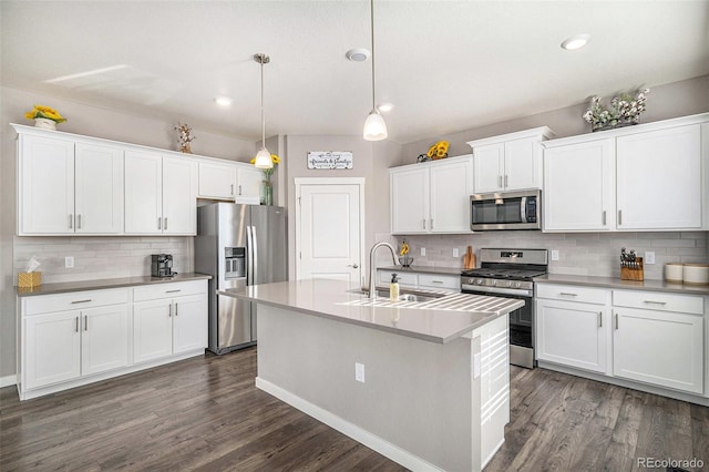 kitchen featuring decorative light fixtures, stainless steel appliances, and backsplash