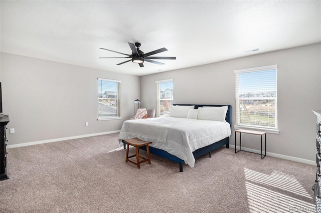 bedroom featuring light colored carpet and ceiling fan