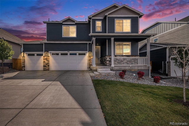 craftsman-style home with a yard, a porch, and a garage