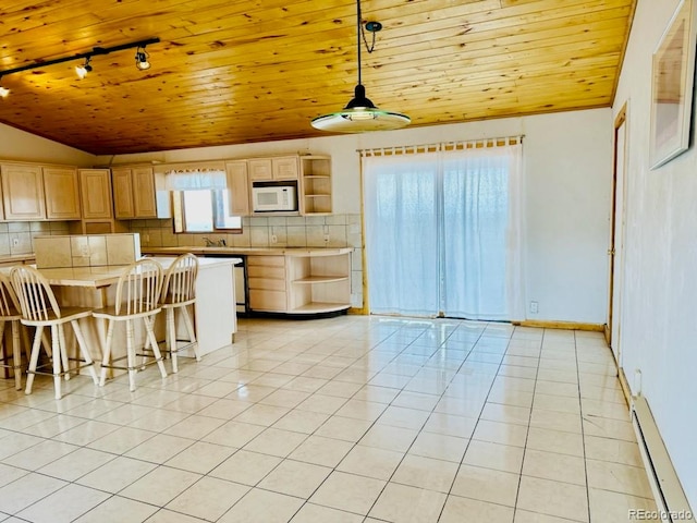 kitchen featuring light brown cabinets, wood ceiling, white microwave, a breakfast bar, and light tile patterned floors