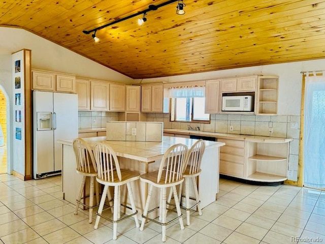 kitchen featuring white appliances, tile countertops, a kitchen island, wood ceiling, and lofted ceiling