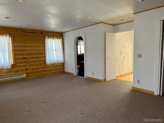 carpeted spare room featuring baseboard heating