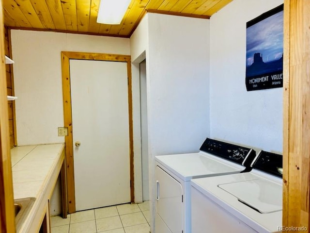 laundry area with independent washer and dryer, light tile patterned flooring, and wooden ceiling