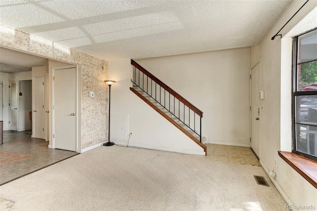 8144 Washington St Unit 192, Denver, CO 80229 - entrance foyer with carpet flooring, stairs, a textured ceiling, and baseboards