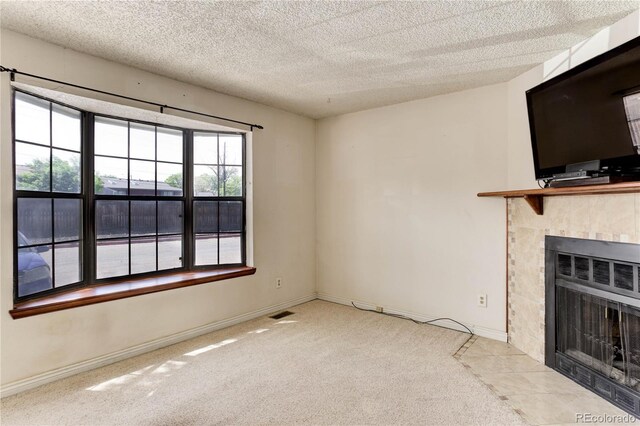 8144 Washington St Unit 192, Denver, CO 80229 - unfurnished living room with a fireplace, carpet, baseboards, and a textured ceiling