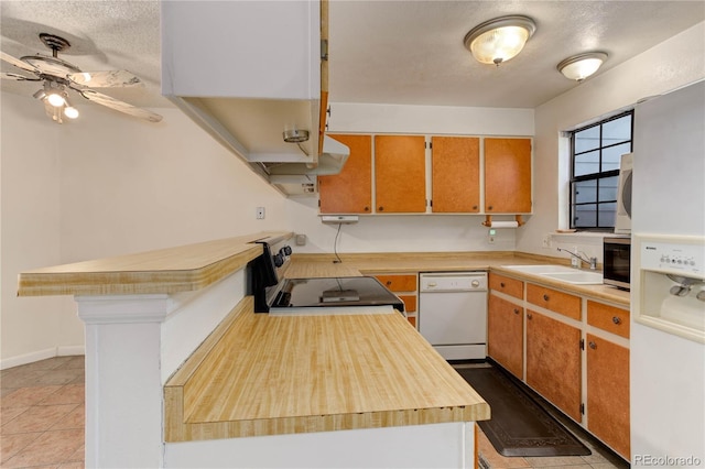 8144 Washington St Unit 192, Denver, CO 80229 - kitchen with white appliances, ceiling fan, a sink, a textured ceiling, and a peninsula