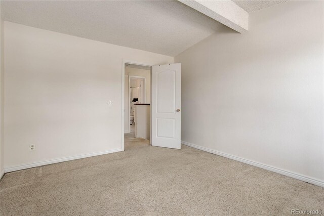 8144 Washington St Unit 192, Denver, CO 80229 - empty room with light colored carpet, a textured ceiling, and baseboards
