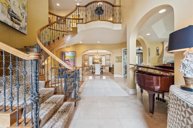 5335 E 2nd Ave, Denver, CO 80220 - foyer featuring arched walkways, a towering ceiling, stairway, a chandelier, and recessed lighting
