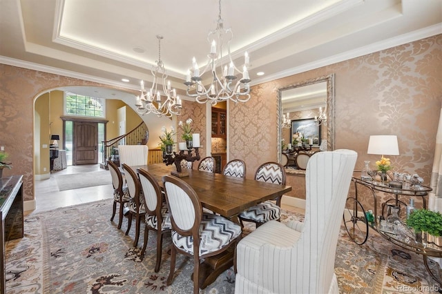 5335 E 2nd Ave, Denver, CO 80220 - dining space with arched walkways, wallpapered walls, a chandelier, a tray ceiling, and ornamental molding