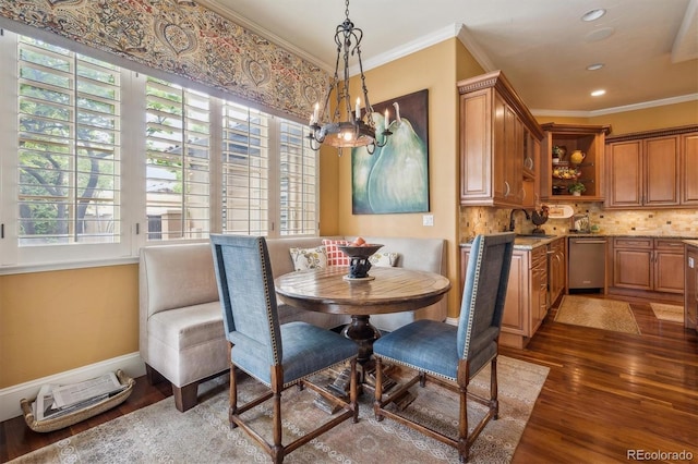 5335 E 2nd Ave, Denver, CO 80220 - dining room with plenty of natural light, wood finished floors, a chandelier, ornamental molding, and baseboards