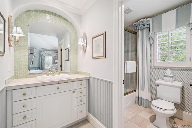 5335 E 2nd Ave, Denver, CO 80220 - full bath with combined bath / shower with glass door, vanity, toilet, and wainscoting