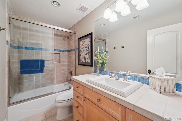 5335 E 2nd Ave, Denver, CO 80220 - full bathroom featuring vanity, enclosed tub / shower combo, toilet, tile patterned flooring, and recessed lighting