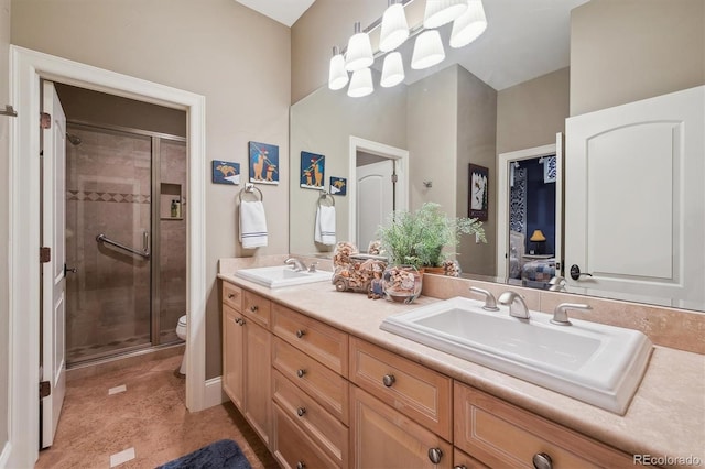 5335 E 2nd Ave, Denver, CO 80220 - bathroom with double vanity, a stall shower, and toilet