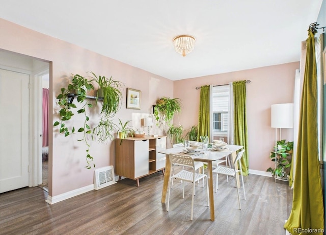 dining area featuring wood finished floors, baseboards, and visible vents