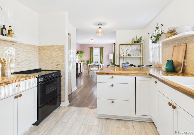 kitchen featuring butcher block countertops, electric range, open shelves, and white cabinets