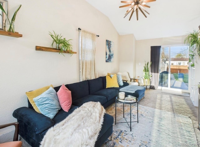 living room featuring a ceiling fan, lofted ceiling, and carpet floors