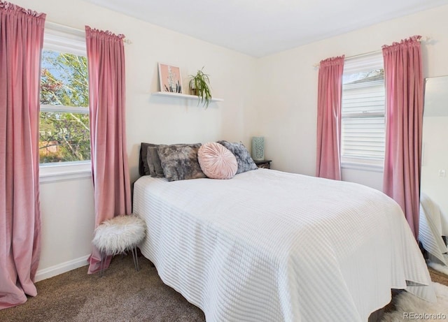 carpeted bedroom featuring baseboards
